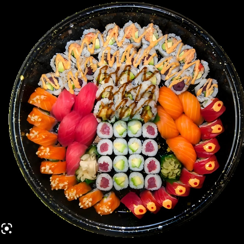 A large, round Saisaki sushi platter filled with various colorful sushi rolls and sashimi.